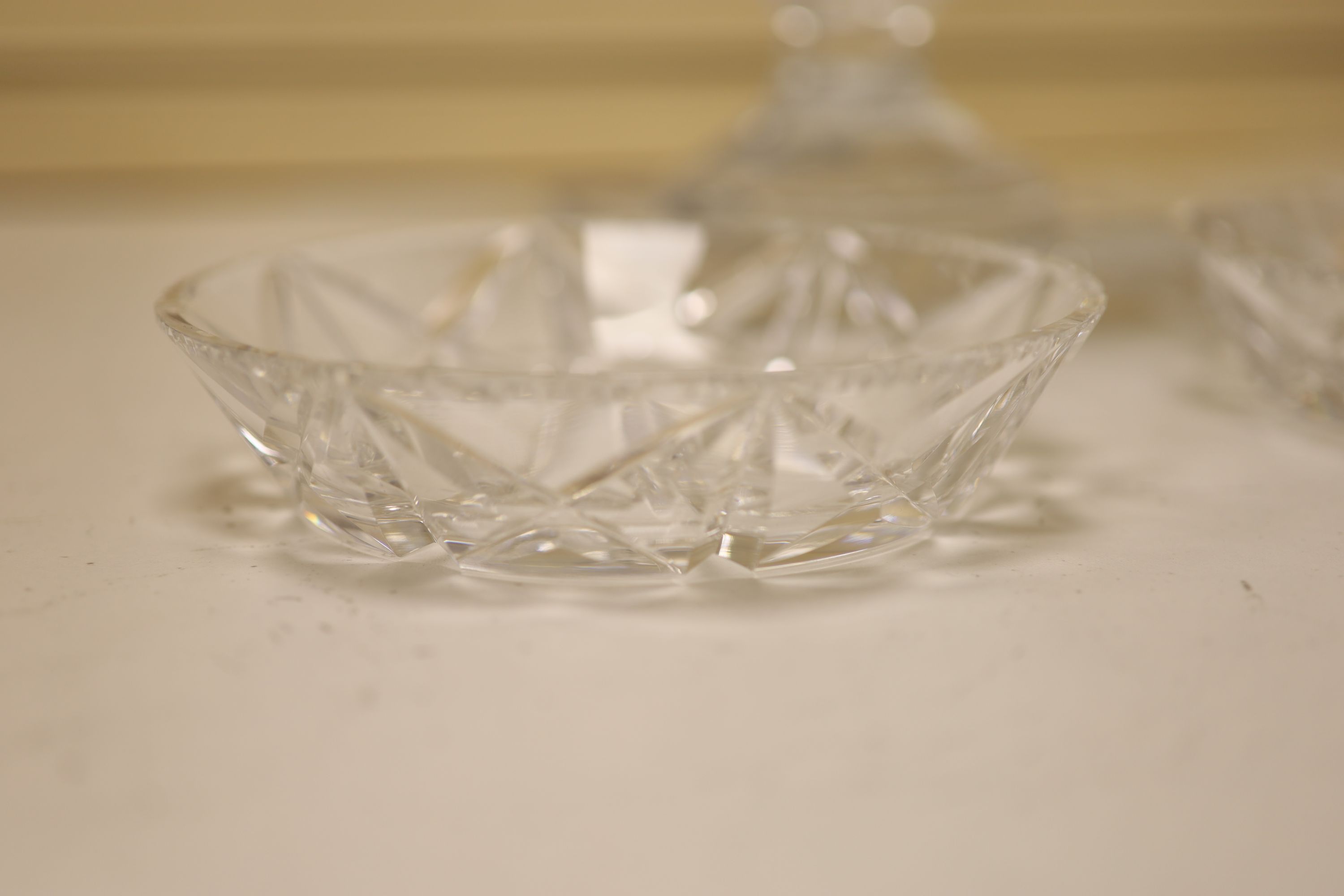 A large and heavy clear cut glass pedestal bowl, 20cm high, and two finger bowls